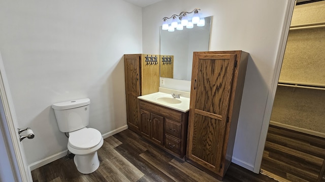 bathroom featuring vanity, toilet, and wood-type flooring