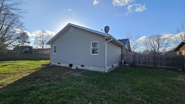 view of home's exterior with central AC and a yard