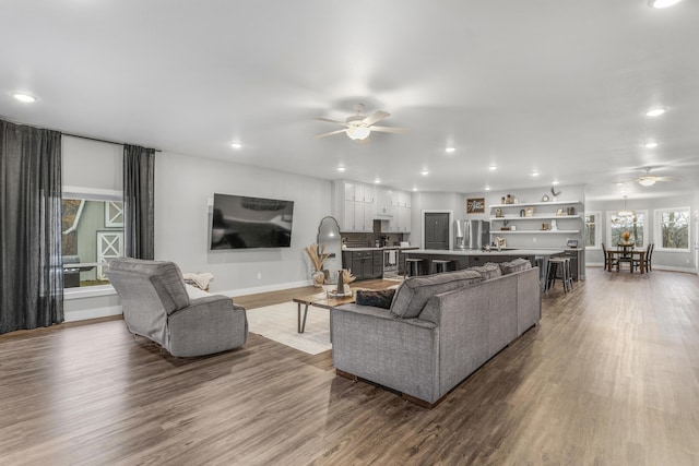 living room with ceiling fan and light hardwood / wood-style floors