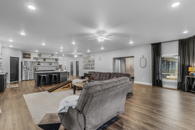 living room with hardwood / wood-style floors and ceiling fan