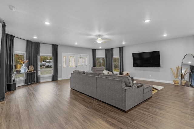 living room featuring dark hardwood / wood-style flooring and ceiling fan