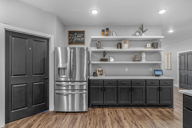 kitchen with stainless steel fridge and hardwood / wood-style flooring