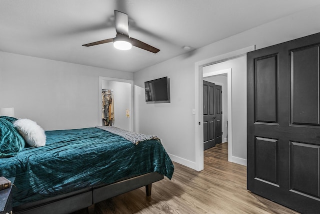 bedroom with hardwood / wood-style floors and ceiling fan