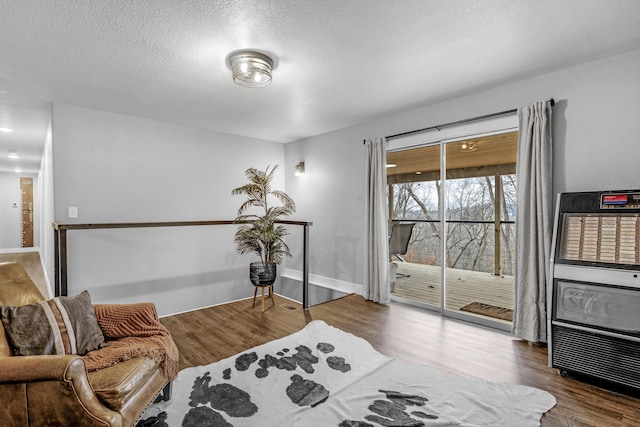 sitting room featuring hardwood / wood-style floors and a textured ceiling