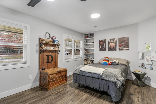 bedroom with dark hardwood / wood-style flooring and ceiling fan