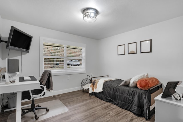 bedroom with hardwood / wood-style floors