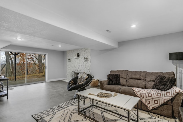 1369 E 398th Rd, Bolivar, MO 65613 - living room featuring concrete floors, recessed lighting, and a stone fireplace