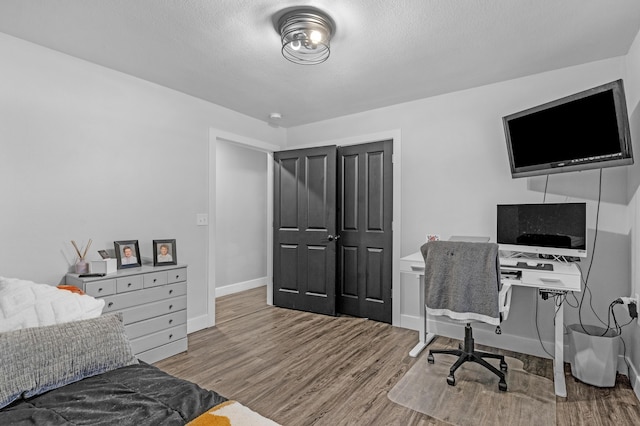 interior space featuring a textured ceiling and light hardwood / wood-style floors