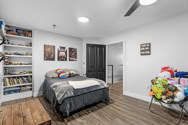 bedroom with ceiling fan and dark wood-type flooring