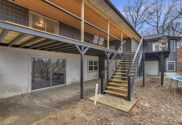 1369 E 398th Rd, Bolivar, MO 65613 - view of patio / terrace with a trampoline, stairway, and a carport