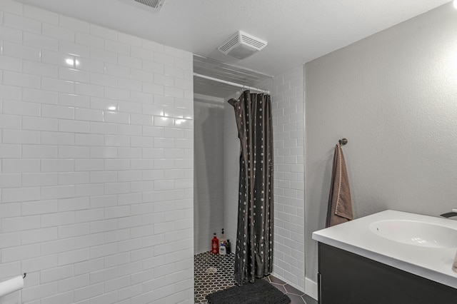 bathroom featuring a shower with curtain, tile patterned flooring, and vanity