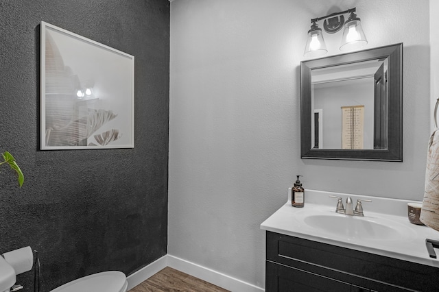 bathroom featuring hardwood / wood-style flooring, vanity, and toilet