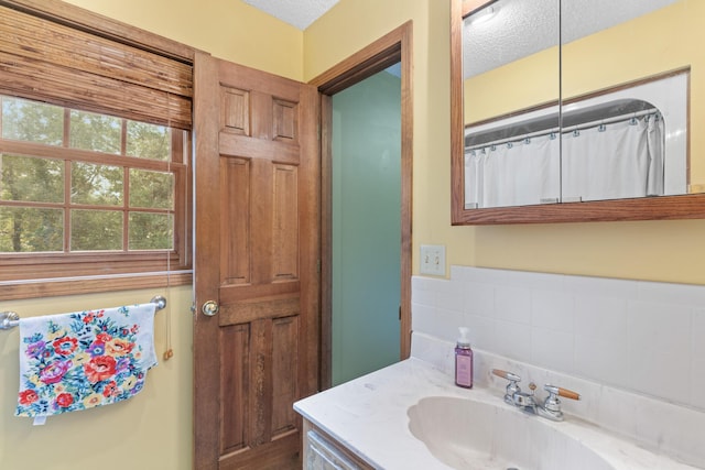 bathroom with vanity, a textured ceiling, and a shower with shower curtain