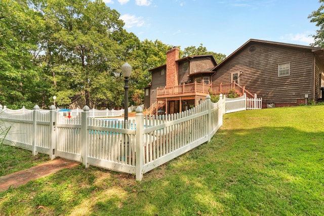 back of property featuring a yard and a fenced in pool