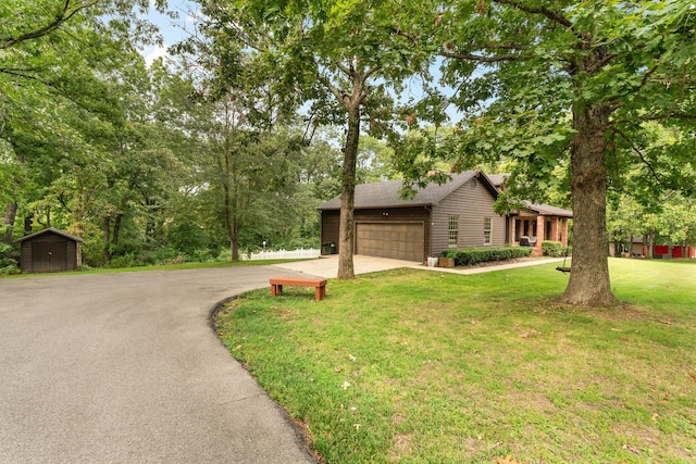 view of front of house featuring a garage and a front lawn