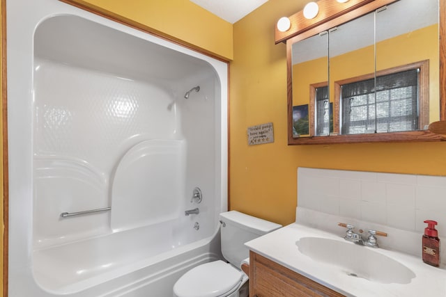 full bathroom with vanity, toilet, washtub / shower combination, and backsplash