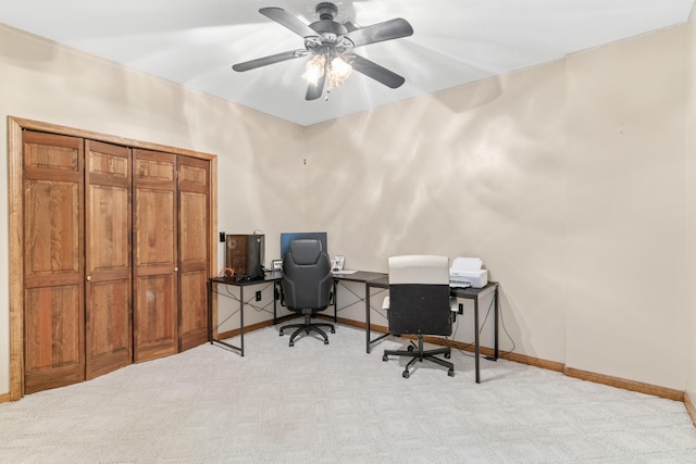 carpeted office space with ceiling fan