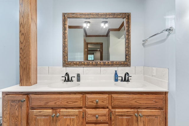 bathroom with decorative backsplash, crown molding, and vanity