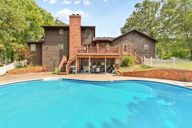 view of pool featuring a wooden deck and a patio area