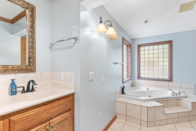 bathroom with tile patterned flooring, vanity, a relaxing tiled tub, and lofted ceiling