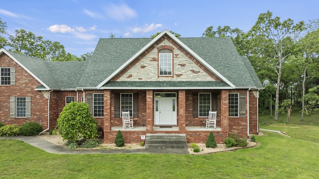 view of front of house featuring covered porch and a front yard