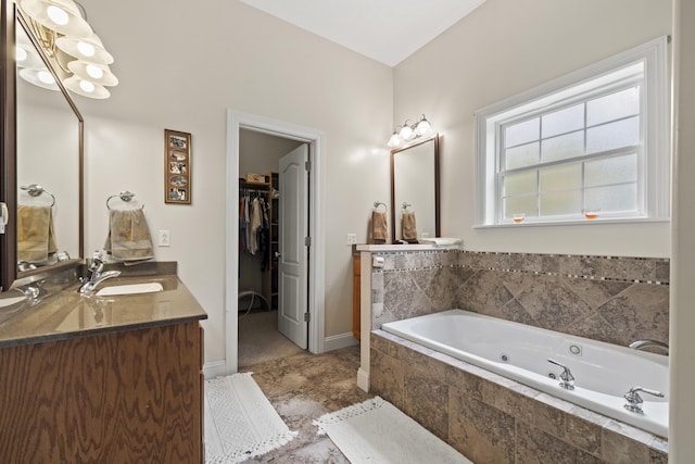 bathroom featuring vanity and tiled tub