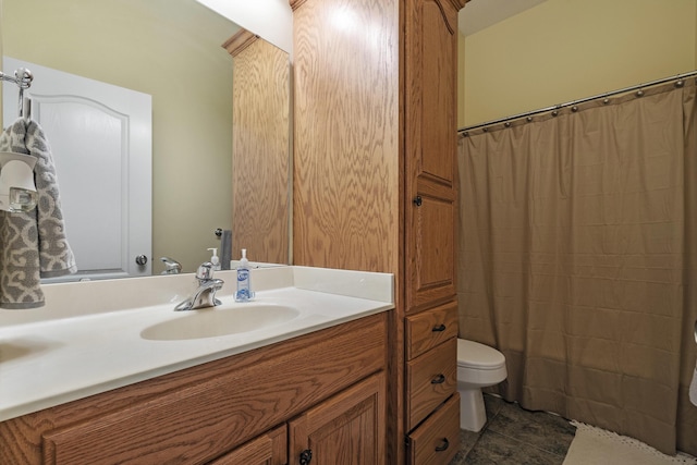 bathroom with walk in shower, vanity, and toilet