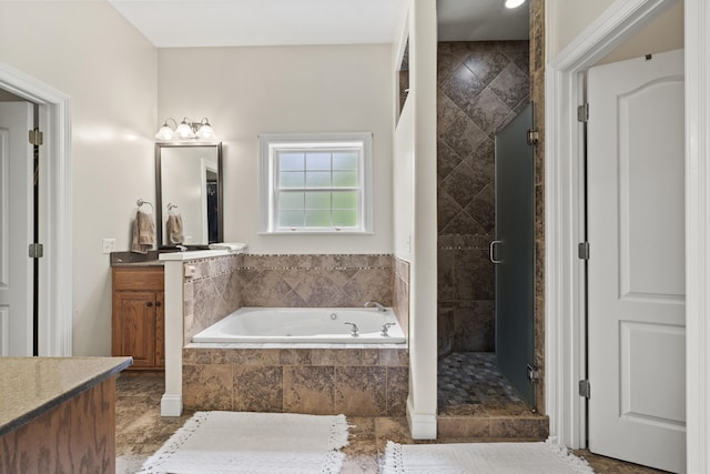 bathroom featuring vanity and independent shower and bath