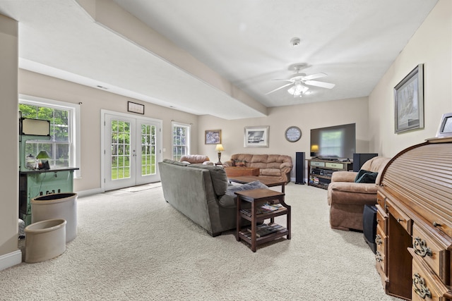 carpeted living room featuring french doors and ceiling fan