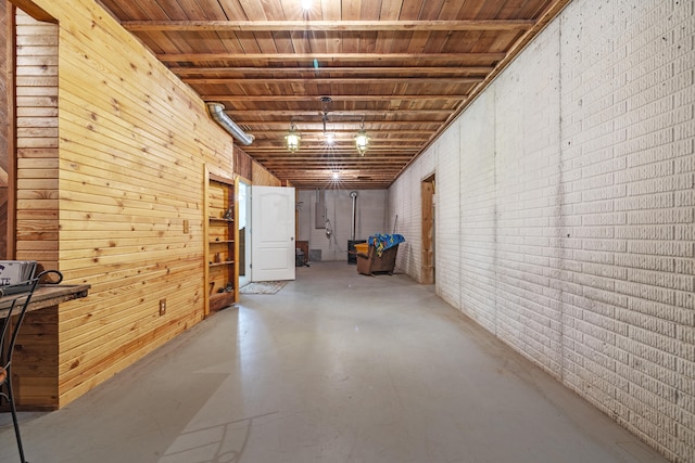 basement with wood walls and brick wall