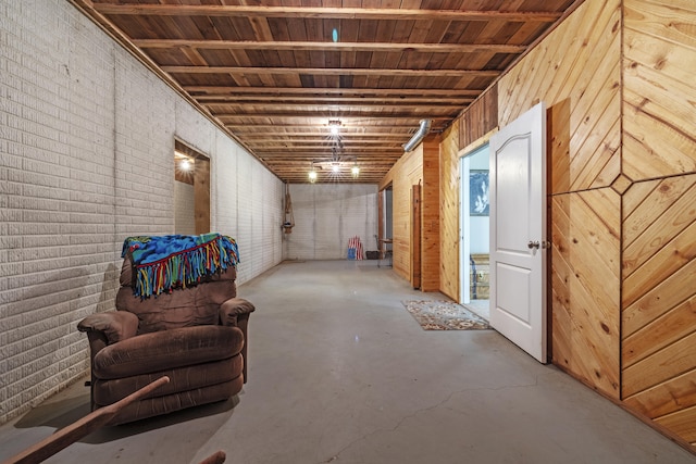 basement featuring wooden walls and brick wall