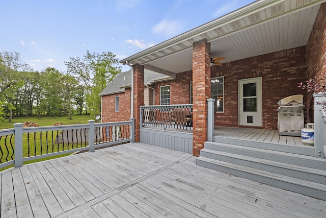 wooden deck featuring a lawn