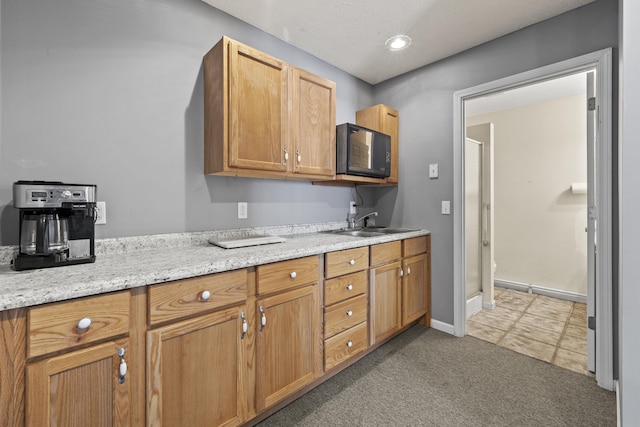 kitchen featuring tile patterned floors and sink