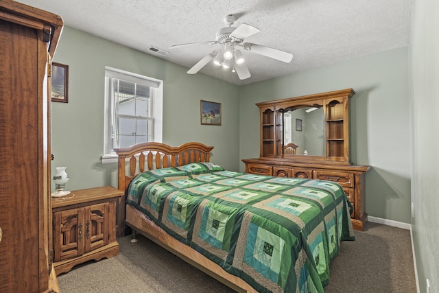 carpeted bedroom with a textured ceiling and ceiling fan