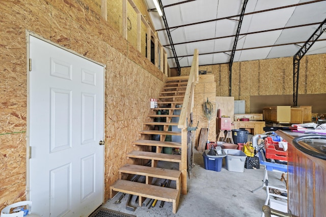 staircase featuring concrete floors