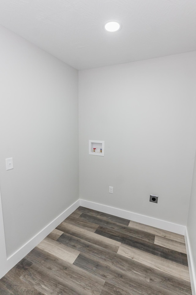 washroom with hookup for an electric dryer, washer hookup, and dark wood-type flooring