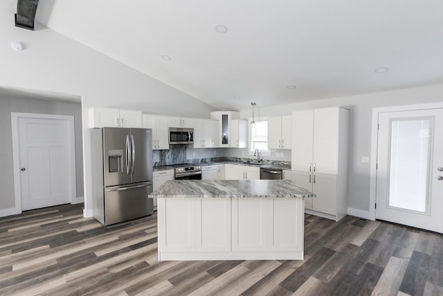 kitchen with pendant lighting, a center island, white cabinetry, and appliances with stainless steel finishes