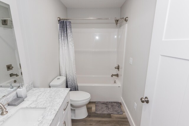 full bathroom with hardwood / wood-style floors, vanity, toilet, and shower / bathtub combination with curtain