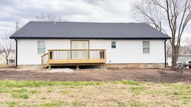 rear view of property with a wooden deck