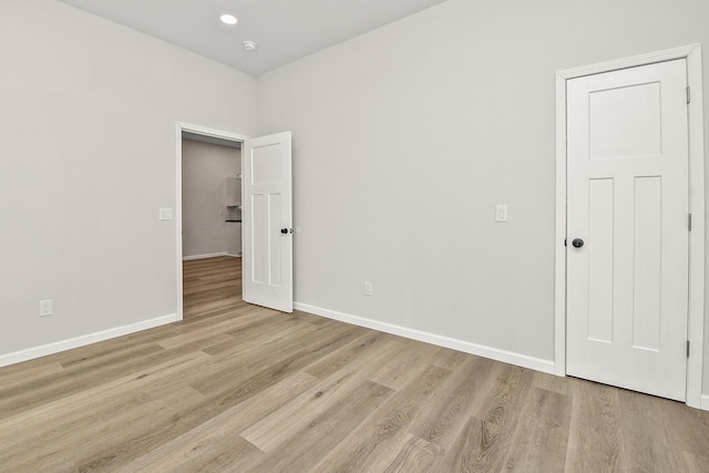 empty room with light hardwood / wood-style flooring