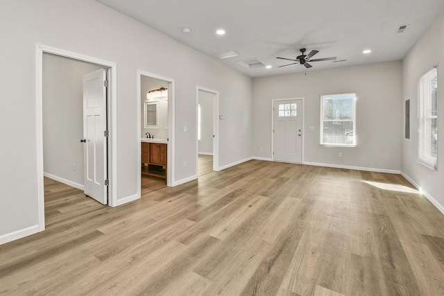 foyer entrance featuring light wood-type flooring and ceiling fan