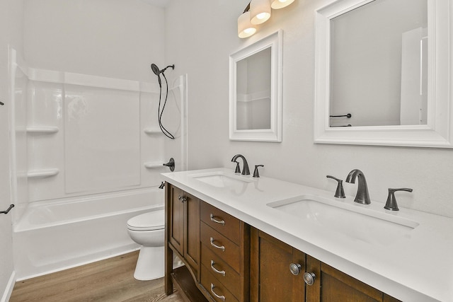 full bathroom with toilet, shower / washtub combination, vanity, and hardwood / wood-style flooring