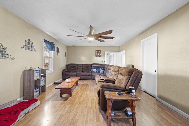 living room with ceiling fan and light hardwood / wood-style flooring