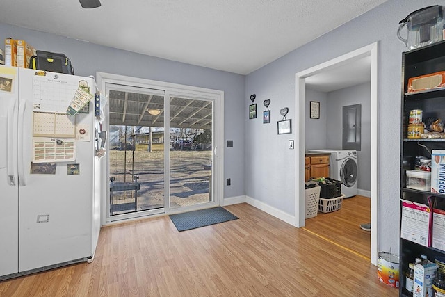 doorway to outside featuring washer / clothes dryer and light hardwood / wood-style floors