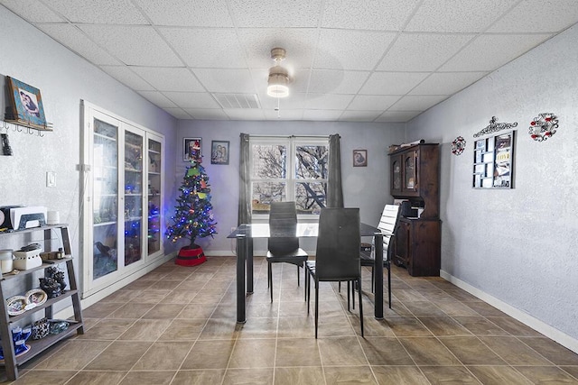 dining room with a drop ceiling