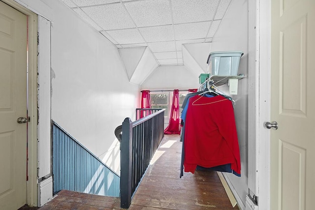 interior space with a drop ceiling and dark hardwood / wood-style floors