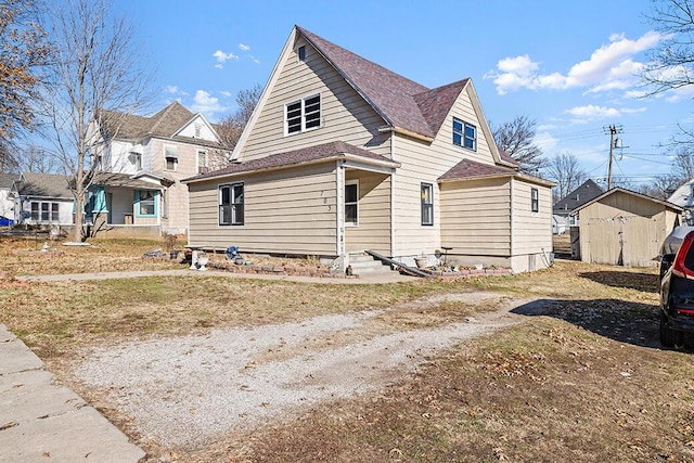 view of side of home featuring a shed