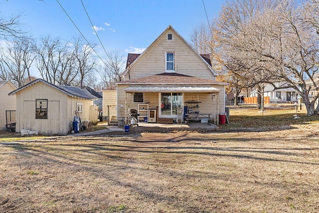 back of property with a storage shed and a yard