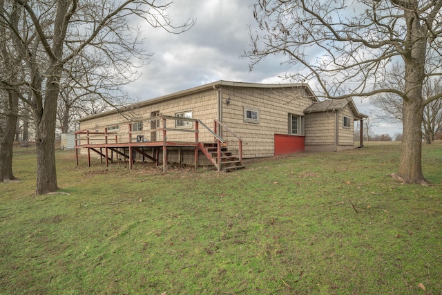 rear view of house with a lawn and a deck