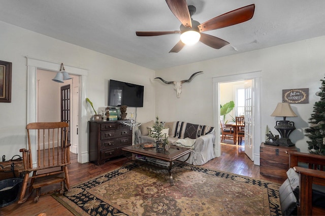 living room with dark hardwood / wood-style floors and ceiling fan